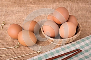 Set Eggs in a basket on gunny sackcloth background