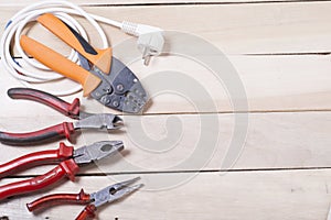 Set of electrical tool on wooden background. Accessories for engineering work, energy concept.