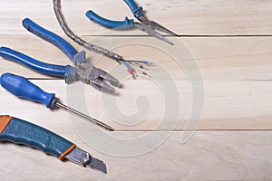 Set of electrical tool on wooden background. Accessories for engineering work, energy concept.