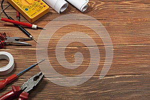 Set of electrical tool on wooden background. Accessories for engineering work, energy concept.