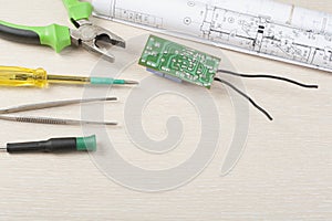 Set of electrical tools on wooden background. Accessories for engineering work, energy concept.Copy space for text.