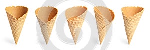 Set of empty crispy wafer ice cream cones on white background