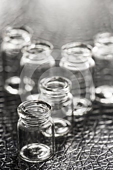 Set of Empty little bottles with black leather background