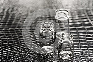 Set of Empty little bottles with black leather background