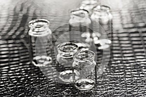 Set of Empty little bottles with black leather background