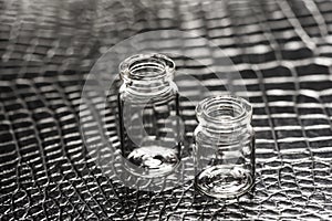 Set of Empty little bottles with black leather background