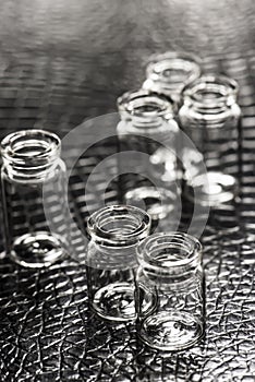 Set of Empty little bottles with black leather background