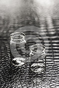 Set of Empty little bottles with black leather background