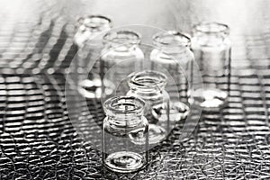 Set of Empty little bottles with black leather background