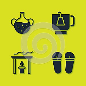 Set Essential oil bottle, Flip flops, Aroma candle and Cup of tea with tea bag icon. Vector