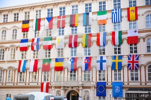 Set of European flags hanging on building with EU and UN flags in Vienna, Austria