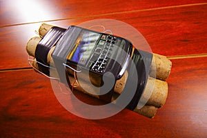 Set of explosives conected to a cellphone laying on the ground