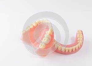 Set of false teeth on white background