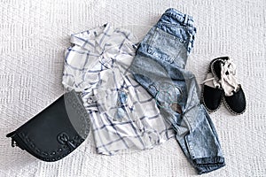 Set with fashionable women`s clothing, shirt, jeans, and bag .Trendy hipster look. Flat lay