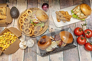 Set of fast homemade food dishes with assorted burgers, nachos