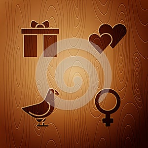 Set Female gender symbol, Gift box, Dove and Heart on wooden background. Vector