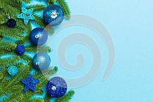Set of festive balls, fir tree and Christmas decorations on colorful background. Top view of New Year ornament concept with copy