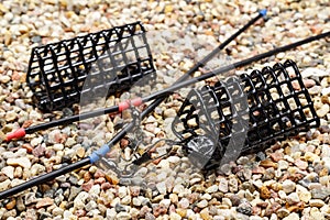 Set of fishing feeding troughs for catching by a feeder on stony ground photo
