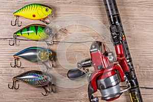 Set of fishing lures, spinning, hooks and lures on wooden background