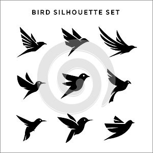Set of flying birds sign logo vector silhouettes isolated on white