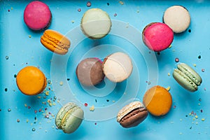 Set of flying colorful macaroons on blue background