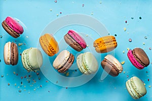 Set of flying colorful macaroons on blue background