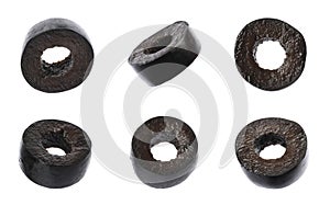 Set of flying cut black olives on white background