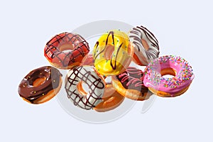 Set of flying glazed donuts with sprinkles on a white background