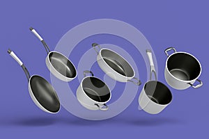 Set of flying stewpot, frying pan and chrome plated cookware on violet