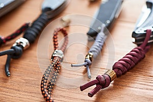 Set of folding knives with various handmade paracord lanyards