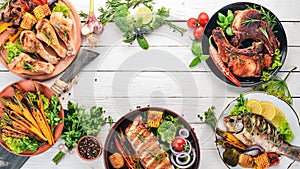 A set of food. Steak, Fish, Vegetables and Spices. On a wooden background.