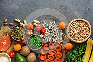 A set of foods high in potassium in a row on a dark background. Healthy balanced meal. Top view, flat lay,copy space