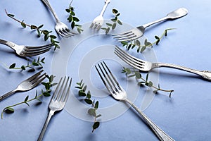 Set of forks on color background