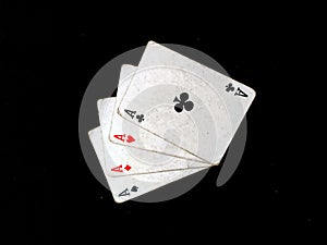 Set of four aces playing cards suits. Winning poker hand isolated on black background