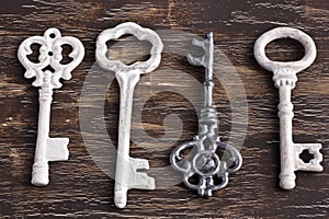 Set of four antique keys, one being different and upside down