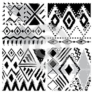 Set of four black and white hand drawn tribal seamless patterns