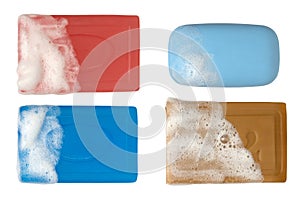 A set of four different bars of soap with foam. Full depth of field.