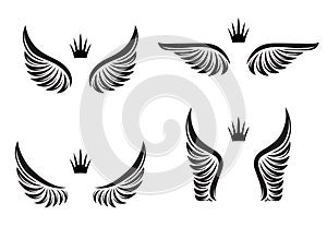 Set of four pairs of wings with crowns. Vector illustration