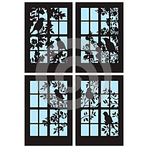 A set of four silhouettes of windows with birds