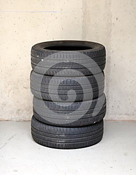 Set of four stacked used car tires