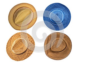 Set of four straw hats isolated on white background