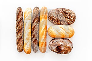 Set of fresh homemade bread. Bread assortment. Loaf, baguette. White and brown bread on white background top view