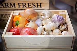 Set of fresh organic vegetables lie in a light wooden box close-up. Concept of biological, bio products, bio ecology