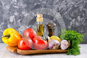 Set of fresh raw vegetables. Tomato, bell pepper, garlic, dill and lemon on a wooden tray. Healthy eating. Organic food