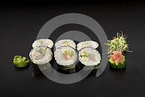 Set fresh sushi rolls decorated with seaweed salad