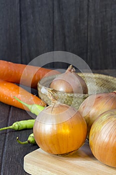 Set fresh vegetables with green leaf on a wooden floor.