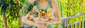 Set of fresh vegetables in a reusable bag in the hands of a young woman. Zero waste concept BANNER, LONG FORMAT