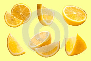 Set of fresh whole and cut Lemon and slices isolated on Yellow background. From top view