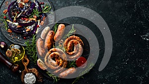 Set of fried barbecue sausages with rosemary and sauces.
