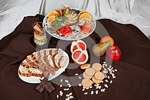 Set of fruit and cakes on a table